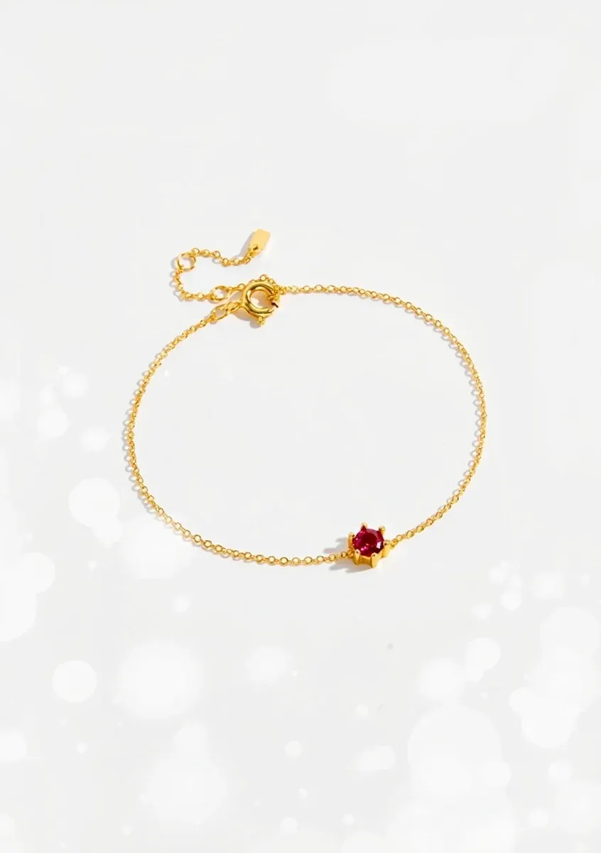 Златиста гривна с червен циркон